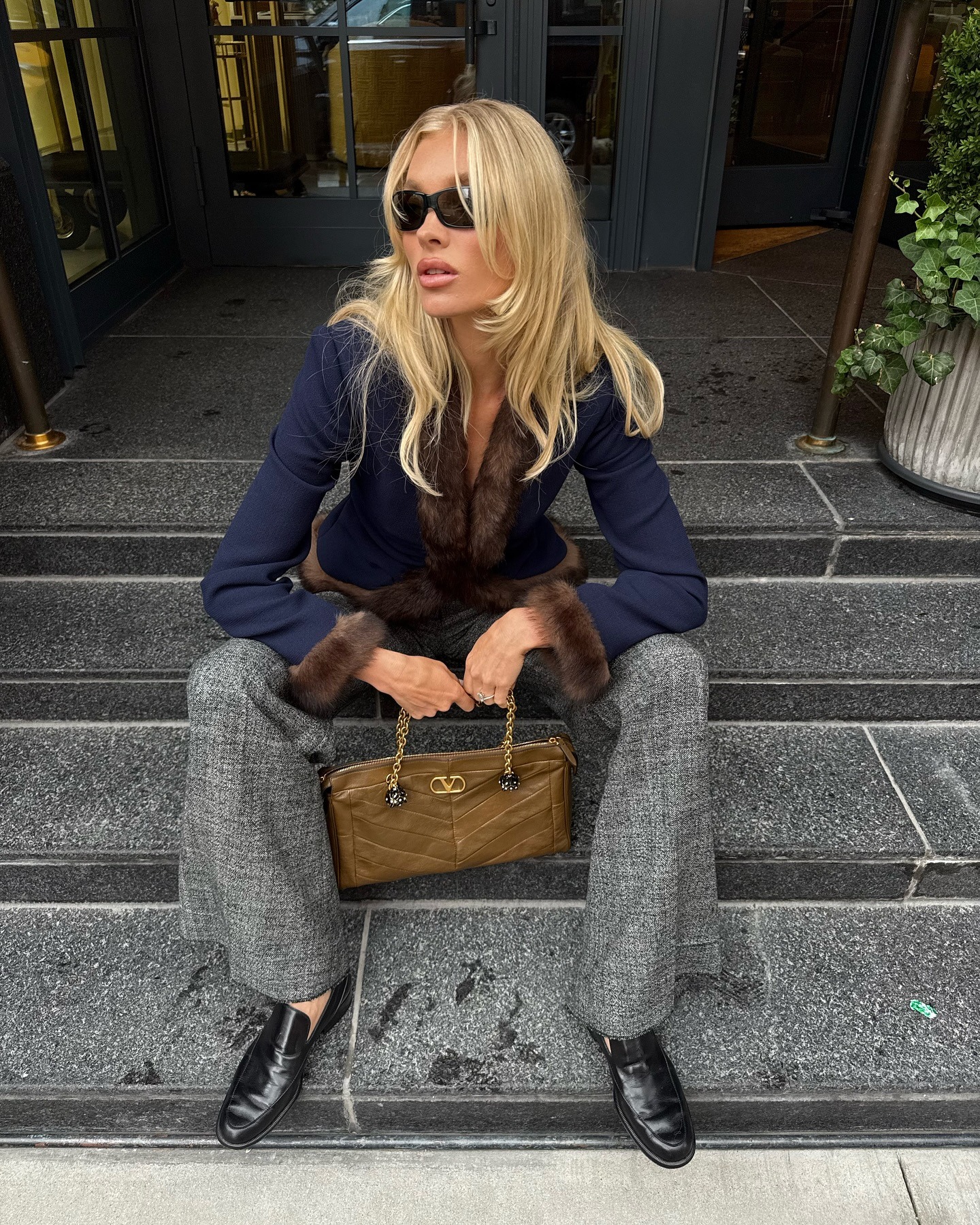 Elsa Hosk wearing a navy jacket and gray pants in NYC