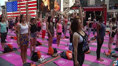 People celebrate International Yoga Day in Times Square
