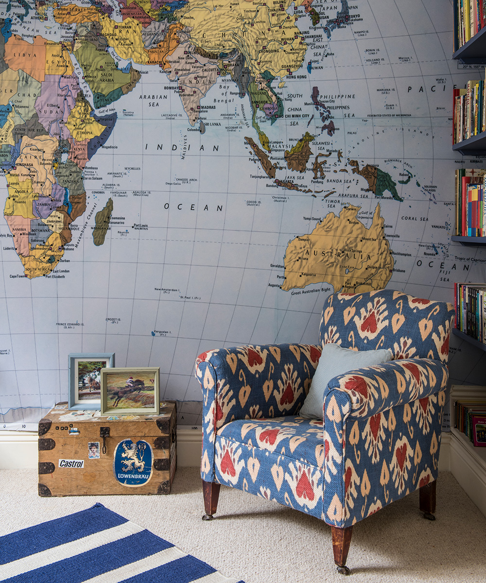 A map of the world-printed wallpaper behind book shelves