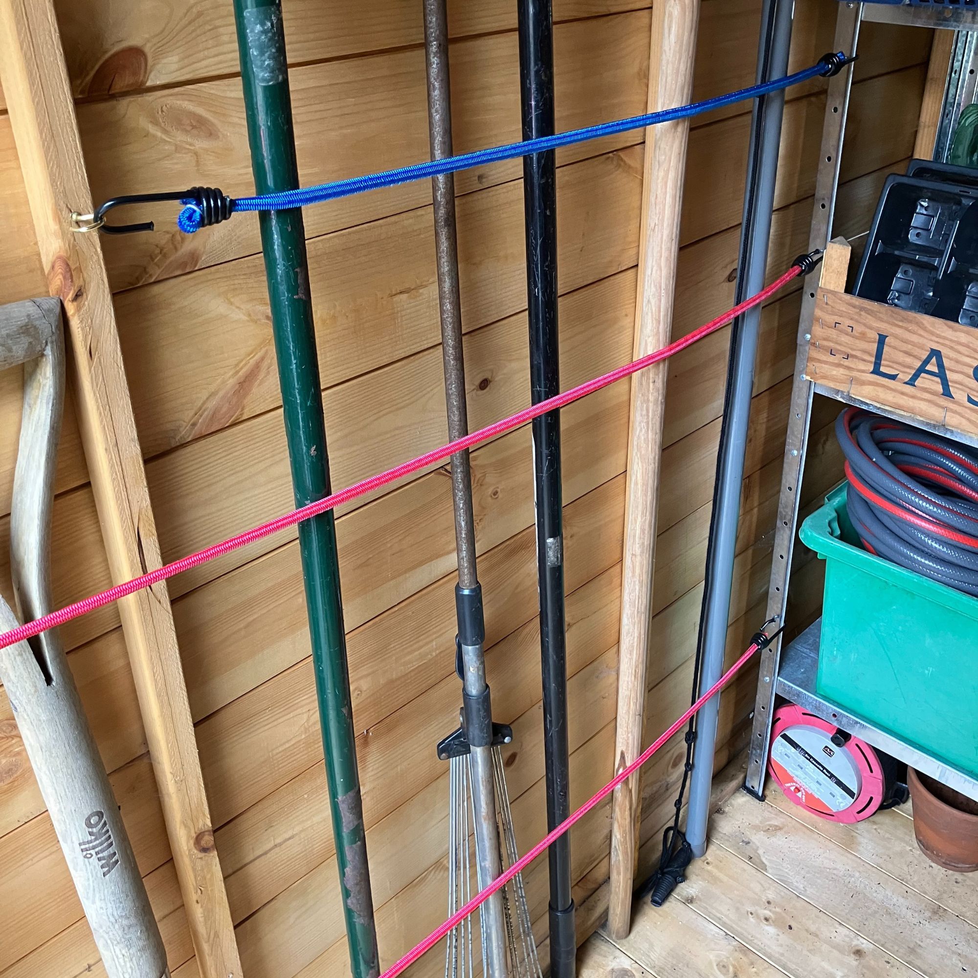 bungee cord shed storage with garden tools