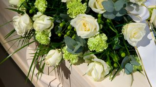 close-up of flower arrangement placed on coffin