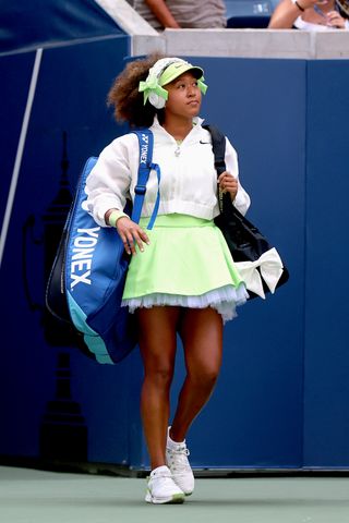 Naomi Osaka wears a brat green tennis dress with ruffles on Day 2 of the US Open at USTA Billie Jean King National Tennis Center on August 27, 2024 in New York City