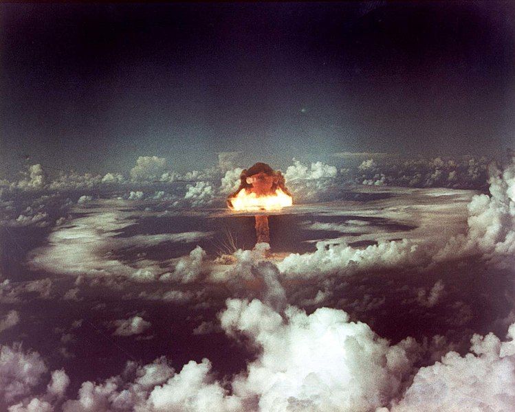 a photo of the detonation of an atoll during operation ivy in 1952, showing a mushroom cloud above the sea