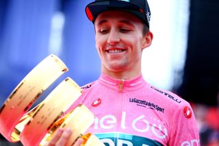 VERONA ITALY MAY 29 Jai Hindley of Australia and Team Bora Hansgrohe Pink Leader Jersey celebrates at podium with the Trofeo Senza Fine as overall race winner during the 105th Giro dItalia 2022 Stage 21 a 174km individual time trial stage from Verona to Verona ITT Giro WorldTour on May 29 2022 in Verona Italy Photo by Tim de WaeleGetty Images