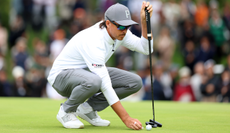 Rickie Fowler lines up a putt