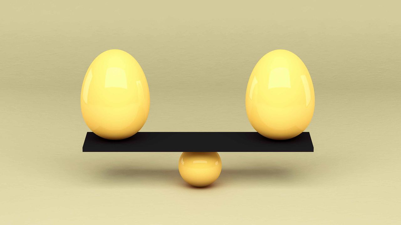 two yellow eggs balancing