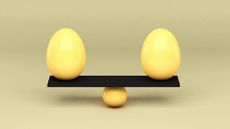 two yellow eggs balancing