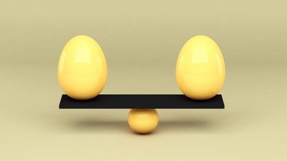 two yellow eggs balancing