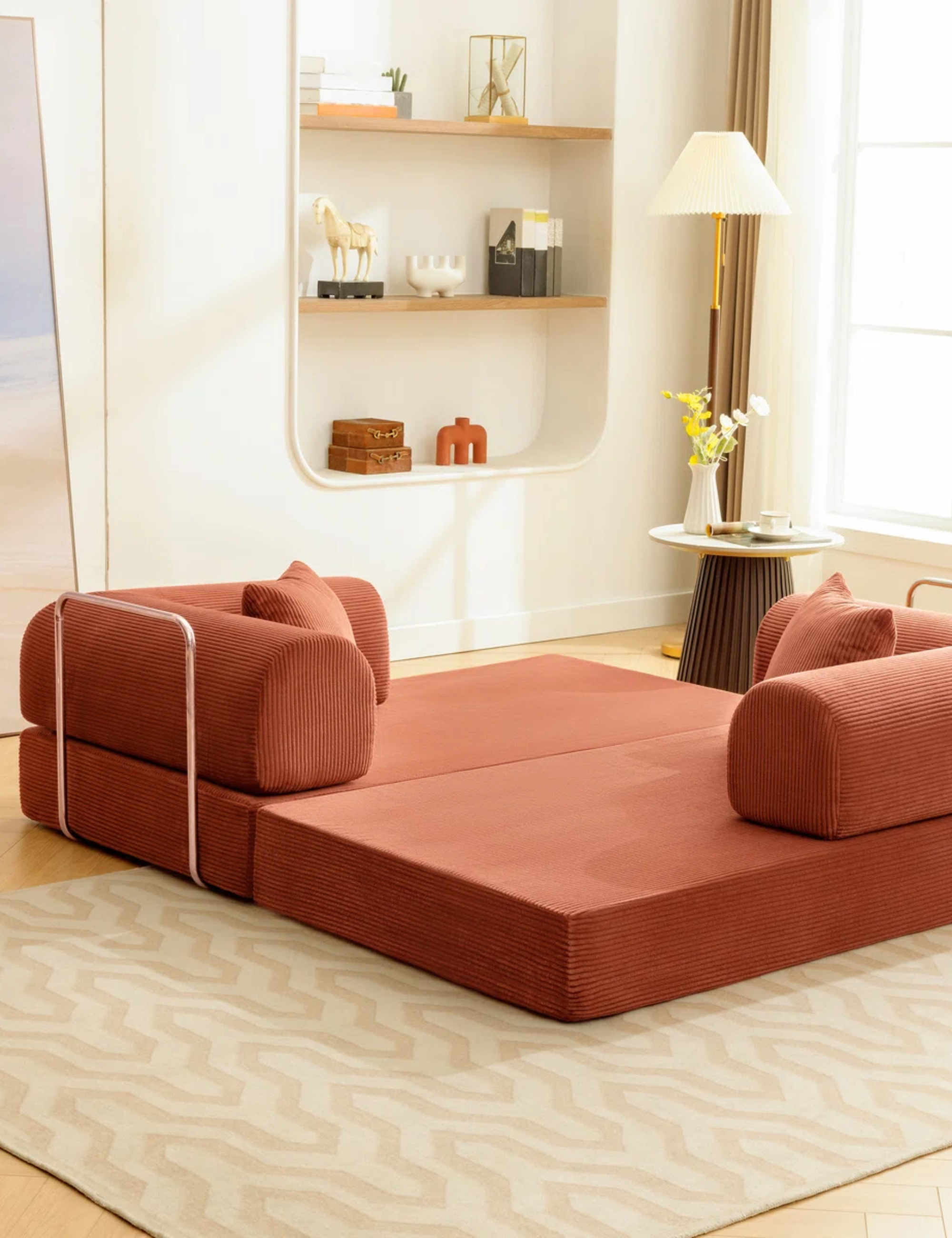 Terracotta conversation pit styled in a cream-colored living room alongside a fluted side table and floor lamp.