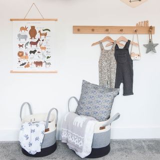 children room with clothes basket and animal alphabet chart on wall