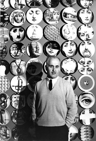 Piero Fornasetti stands in front of a wall of plates