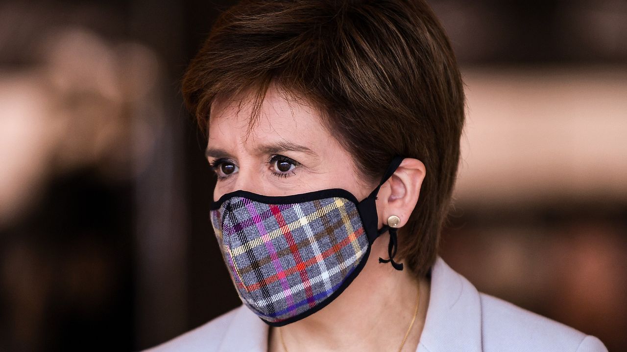 Nicola Sturgeon wearing a tartan print face mask.