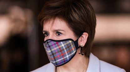 Nicola Sturgeon wearing a tartan print face mask.