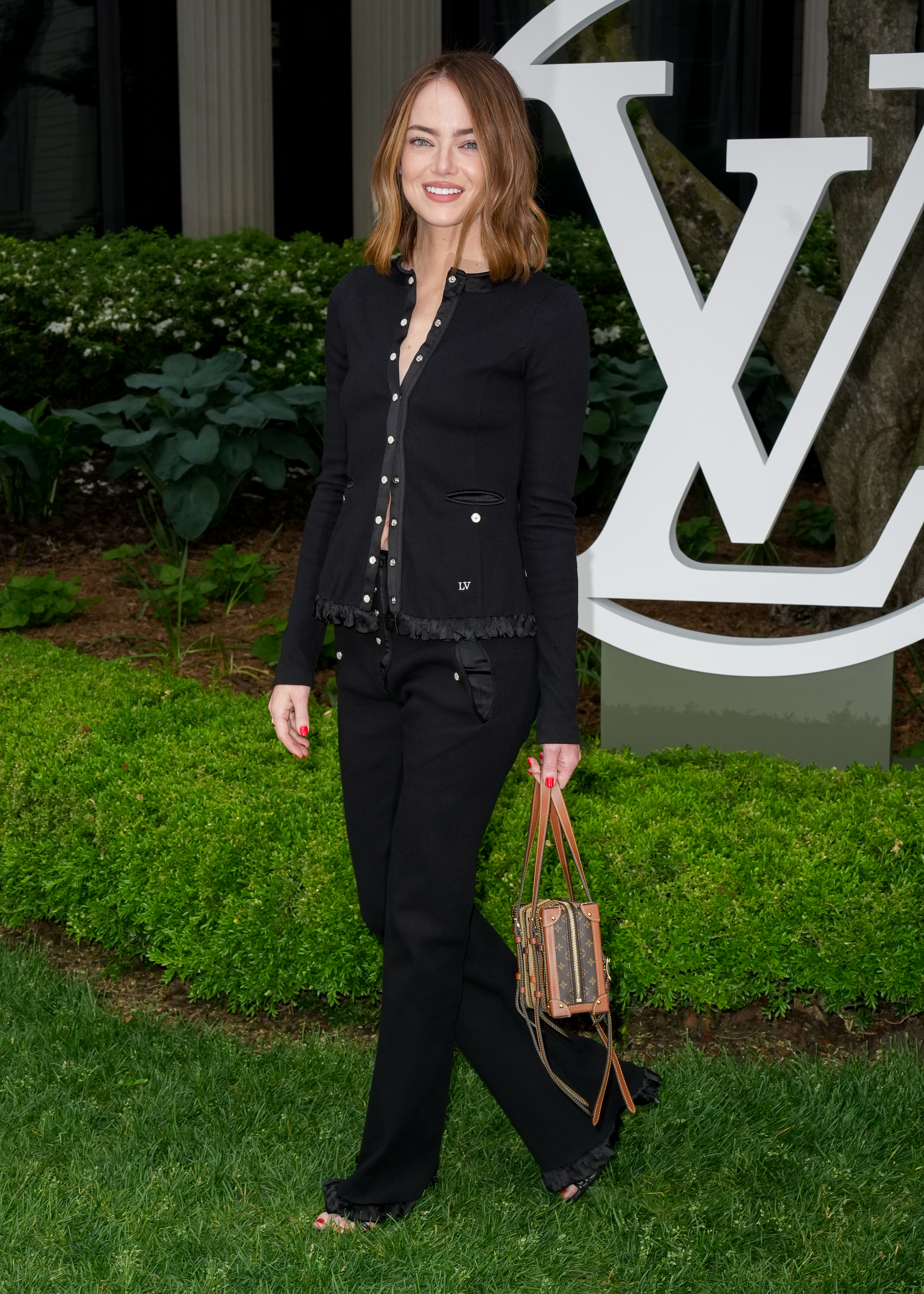 Emma Stone attended the Louis Vuitton Cruise 2027 show in a cozy cardigan set