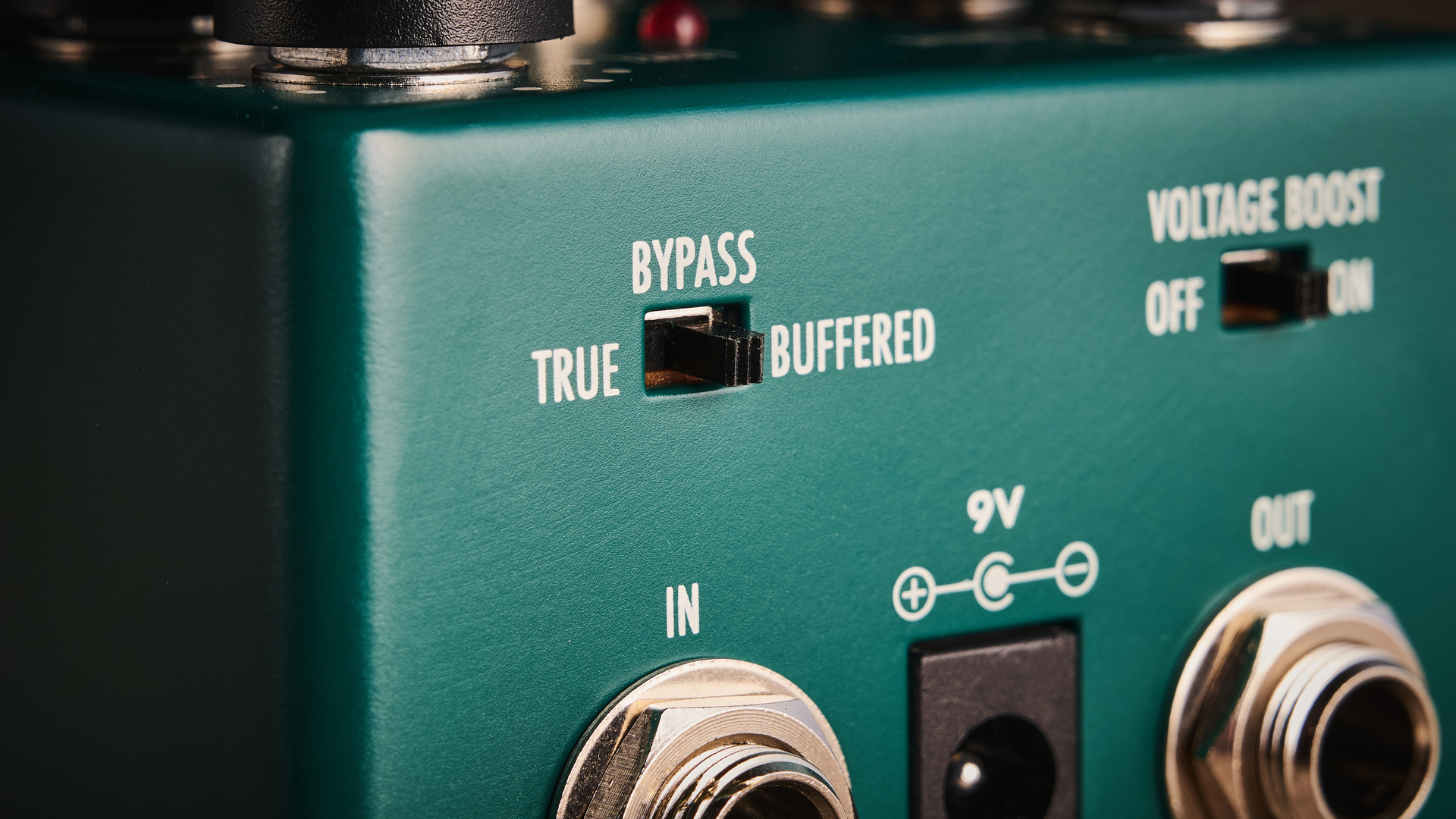 Warm Audio Tube Squealer green overdrive pedal shot on wood floorboards