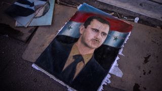 A ripped poster of former Syrian President Bashar al-Assad lies on the ground in Damascus, Syria on 17 December 2024, after the fall of the Assad regime