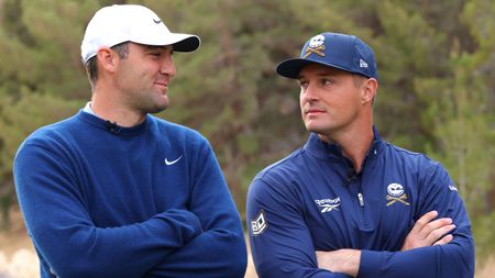 Scottie Scheffler and Bryson DeChambeau look at each other on the golf course