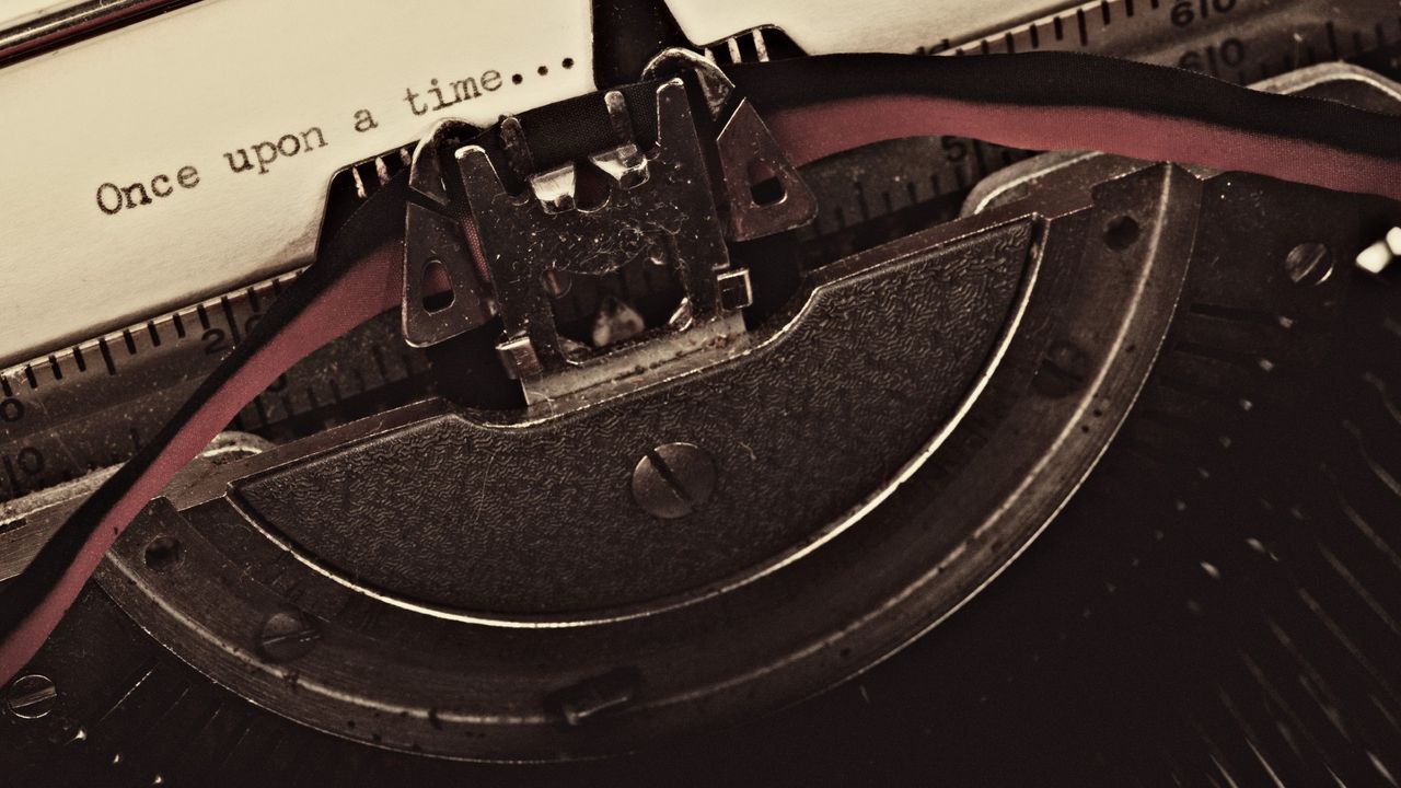 Close-up of a typewriter, with the words Once upon a time types on the page