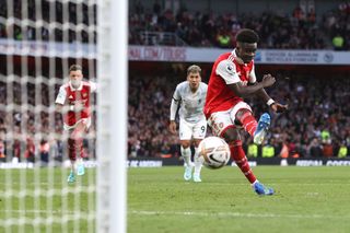Bukayo Saka of Arsenal scores their 3rd goal from the penalty spot during the Premier League match between Arsenal FC and Liverpool FC at Emirates Stadium on October 9, 2022 in London, United Kingdom.