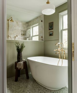 Sage green bathroom with shiplap paneling by Jessica Nelson