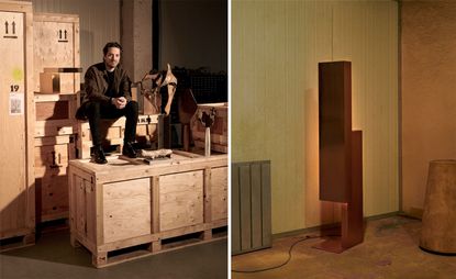 Artist Marcin Rusak sitting on wooden boxes and lamp to the right