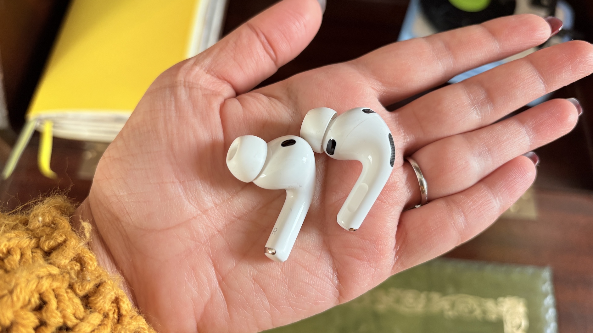 One earbud each of the AirPods Pro 3 and Pro 2 held in the palm of a hand.