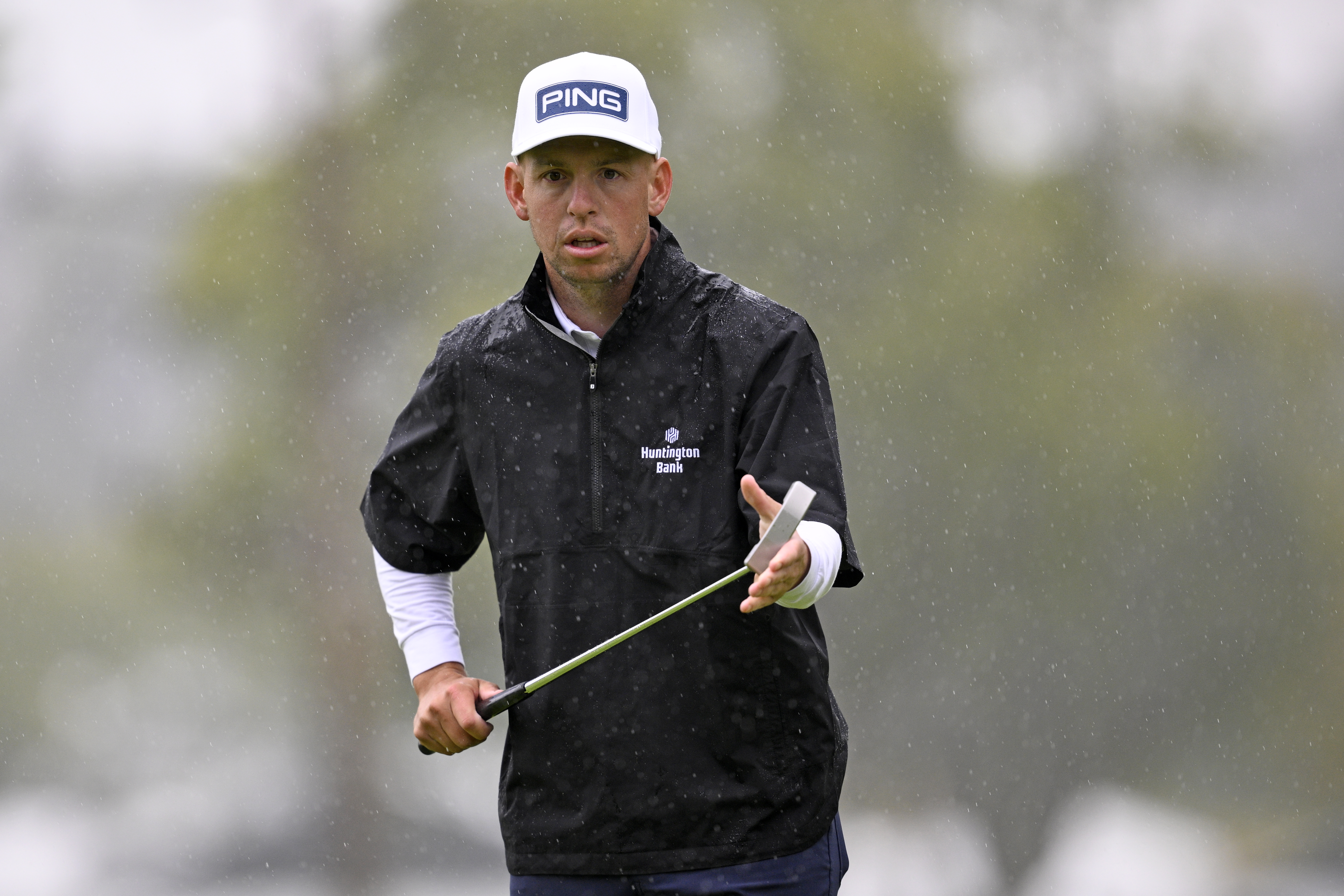 Sam Stevens wipes the face of his golf club