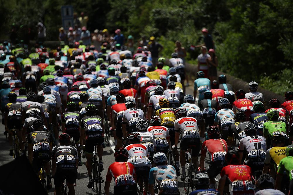 Greg Van Avermaet's yellow jersey is just visible in the middle of the bunch during stage 6.