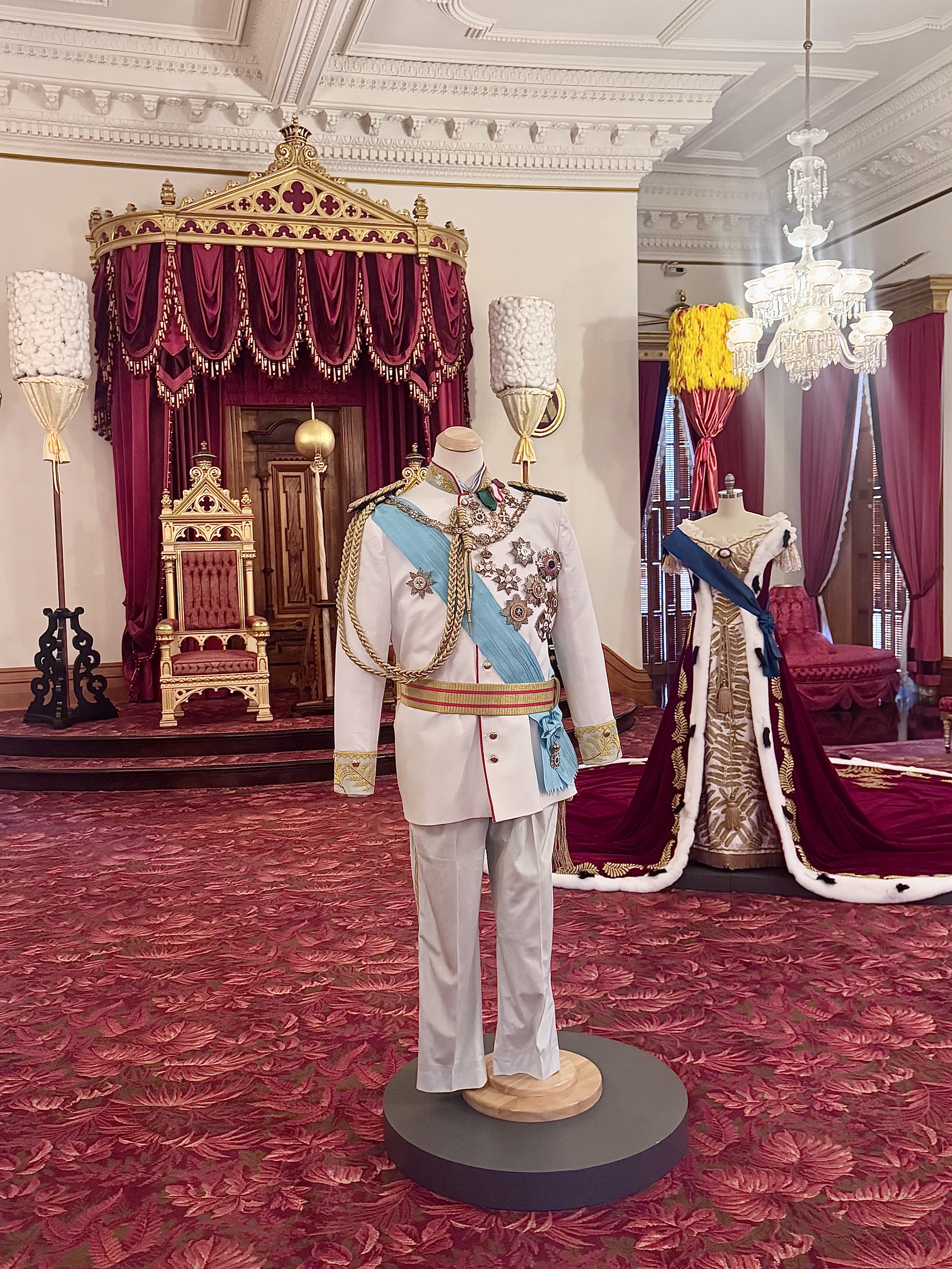The throne room at Iolani Palace with mannequins wearing royal uniforms
