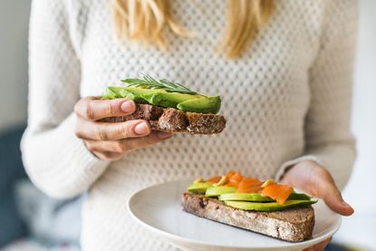 Gut health hacks: a woman eating a balanced breakfast