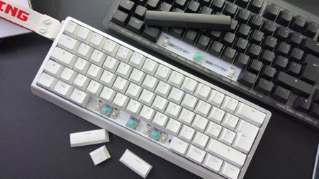 The Wooting 60HE v2 with a split spacebar on a desk alongside the Wooting 80HE with a normal spacebar.