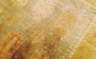 Golden antique carpet job created by Tory Burch