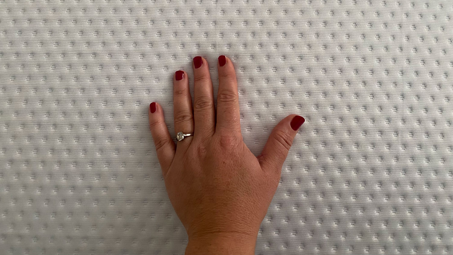 A hand on the Emma Premium mattress