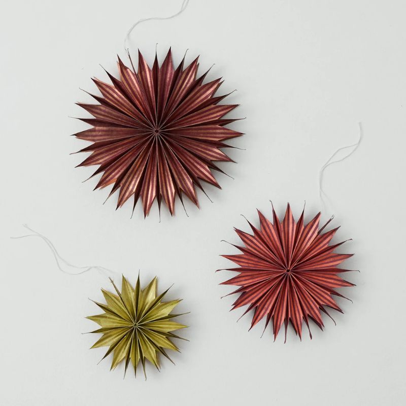 three dark red and gold paper star Christmas decorations