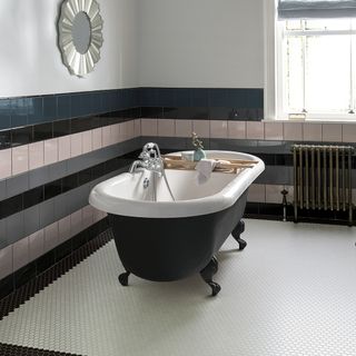 bathroom with grey bathtub grey shaded tile wall and hexagonal designed floor