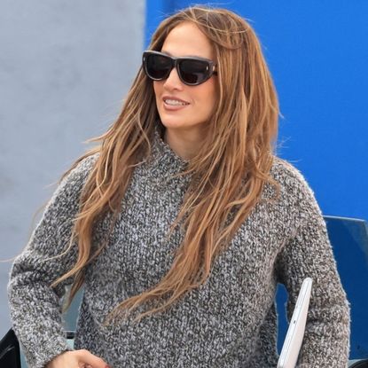 Jennifer Lopez arrived back at her dance studio in black leggings, a chunky sweater, lace-up boots, and a Dior D-Journey bag