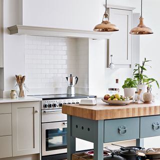 Kitchen with brass pendant lights above island