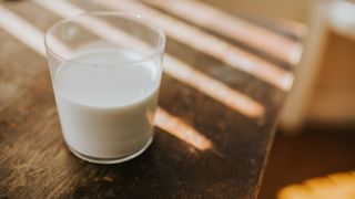 A photograph of a glass of milk.