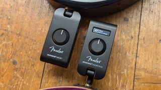 A Fender Mustang Micro and Mustang Micro Plus on a wooden floor