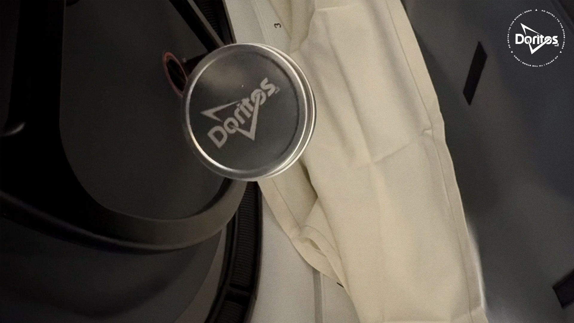 closeup of a doritos canister floating aboard a space capsule