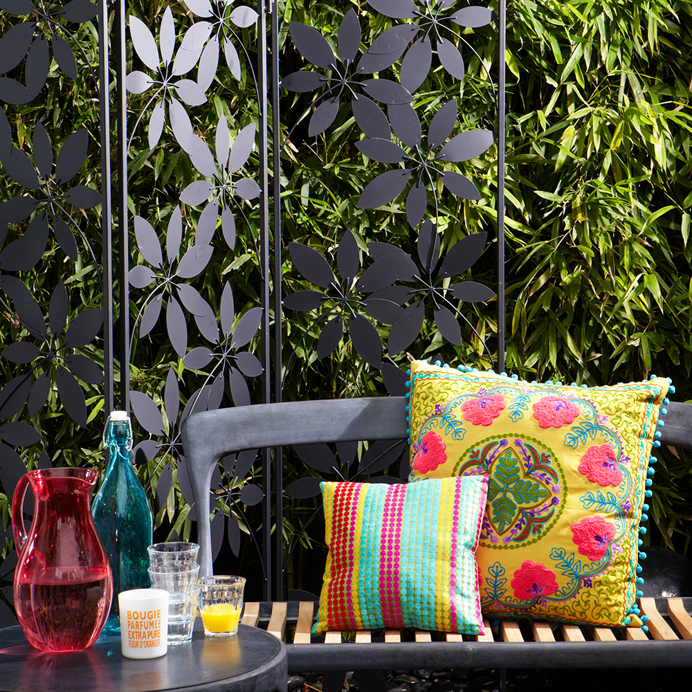 garden bench in front of decorative screen