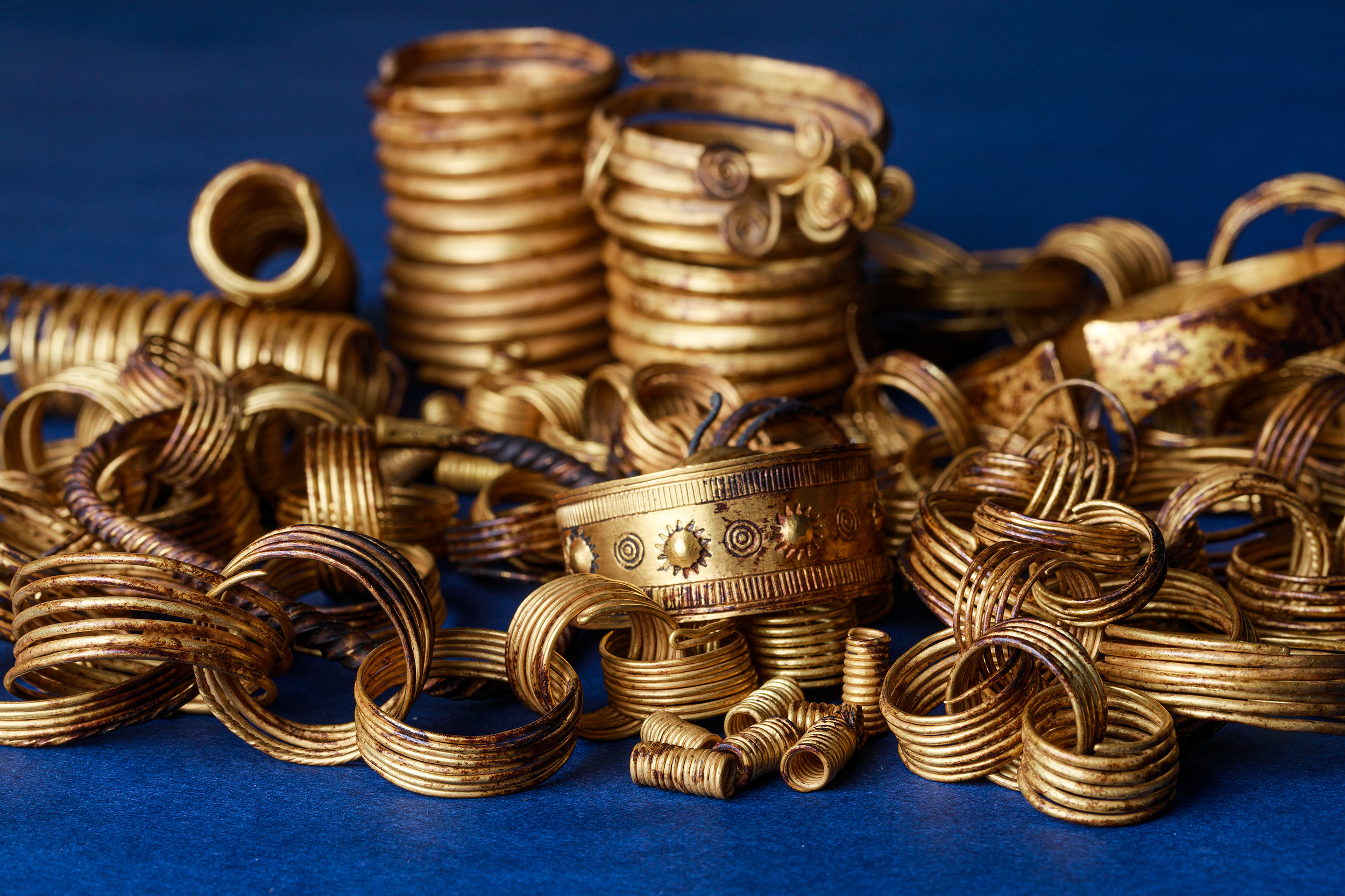 series of gold rings against a blue background