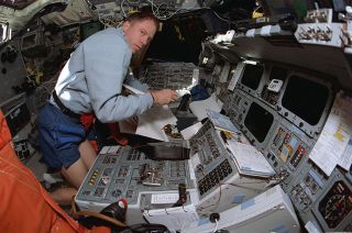 Rick Searfoss, STS-90 commander, is seen aboard the flight deck of the space shuttle Colum-bia in 1998.