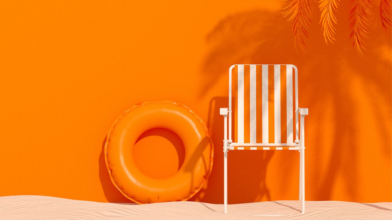 Beach chair and inner tube on sand