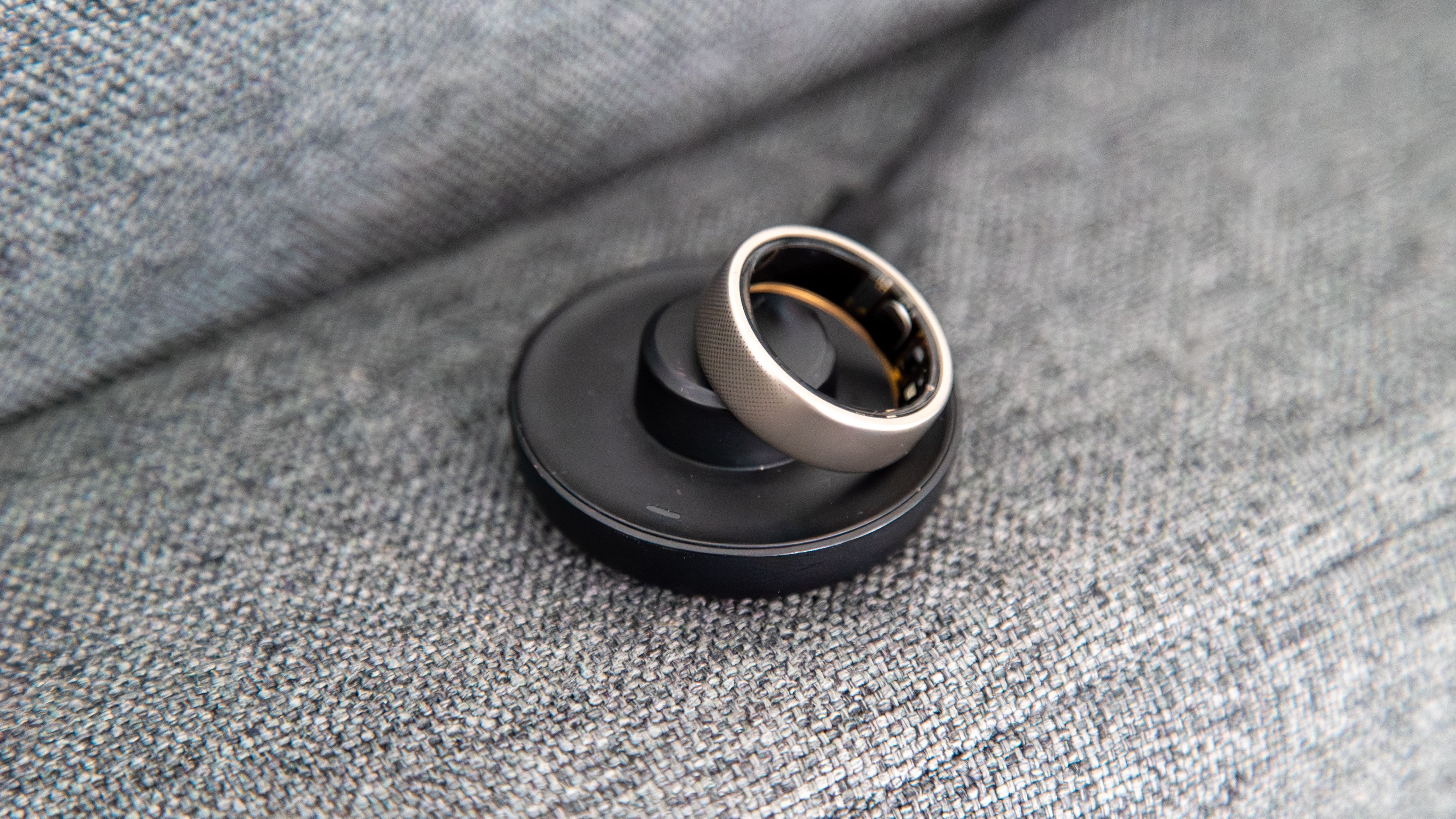 The Amazfit Helio Ring on the charger