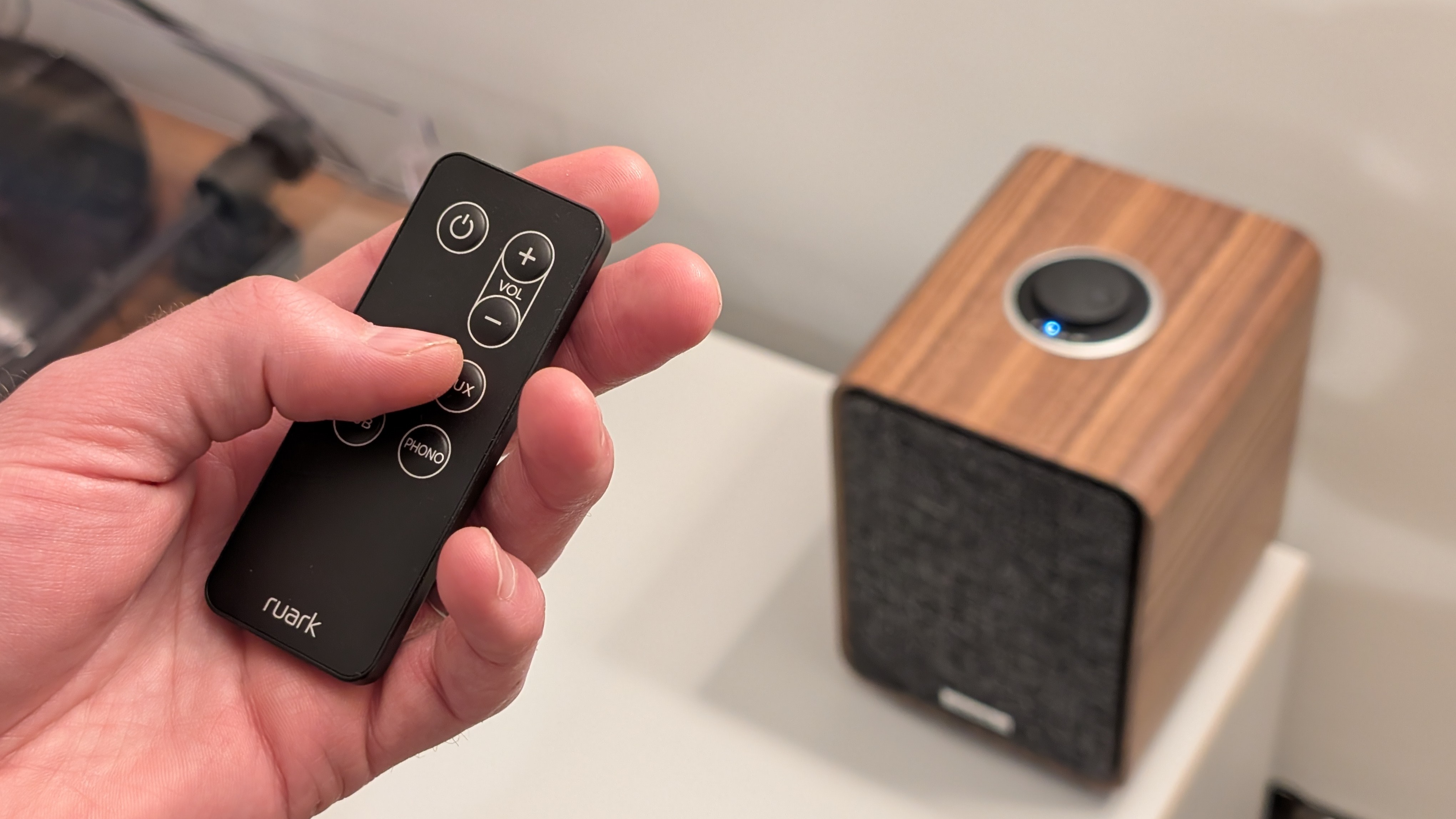 Ruark MR1 MK3 speakers with a remote held in the hand