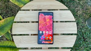 A Google Pixel 6 from the front, on a table, with the screen on