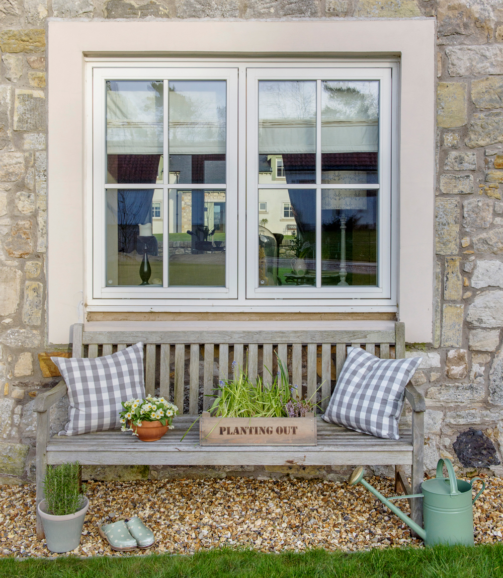 Exterior with window and bench with cushions