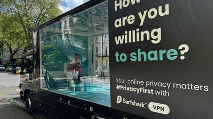 Surfshark's truck featuring a transparent toilet and a person inside in London, in front of Future PLC's office on May 9, 2024. 
