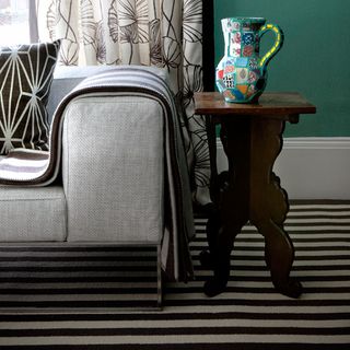 room with striped carpet and couch